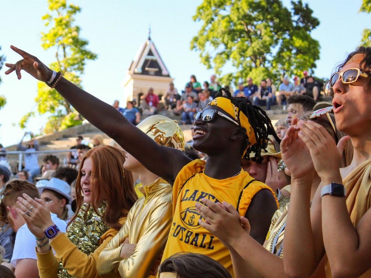 High school students cheer inside the amphitheater on Old Main Hill